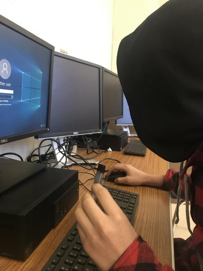 A Gresham student using a juul in class.