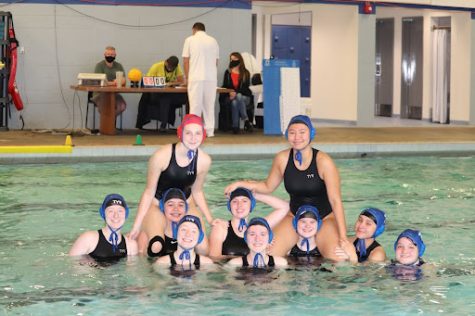 Team photo for varsity girls water polo before beating the Reynolds high raiders 18-12.