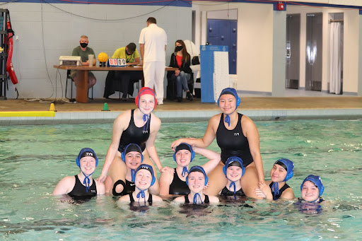 Team photo for varsity girls water polo before beating the Reynolds high raiders 18-12.