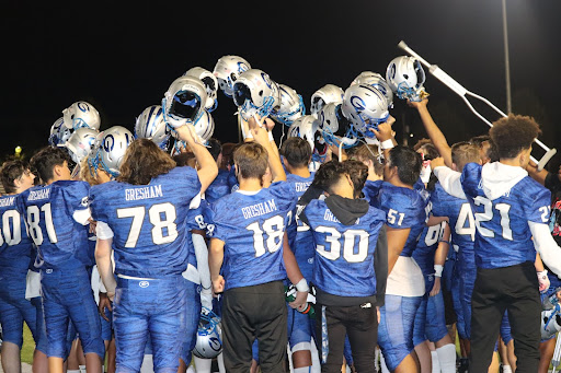 The varsity football team breaking after a victory over Nelson high 26-6.