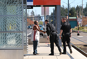 Police officers shaking a Gresham resident's hand.