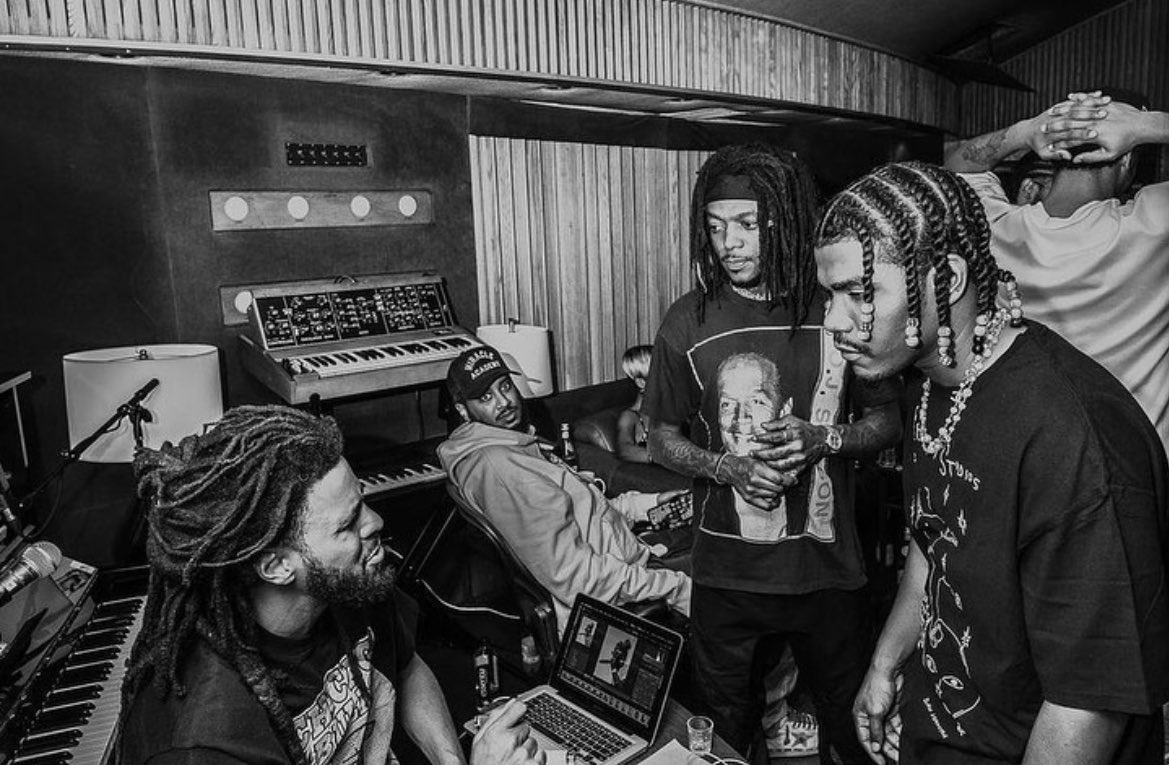Photograph of rappers J Cole, Smino, & JID in the studio together.